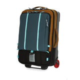 Topo Designs Global Travel Bag Roller carry-on luggage in desert palm and pond blue with multiple compartments and sturdy wheels.