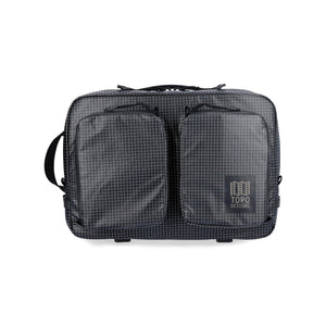 Black Topo Designs Apex Convertible Briefcase with handle and shoulder strap, front view showing sleek design and secure zipper closure.
