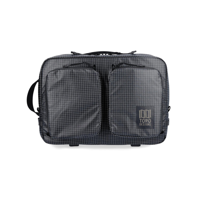 Black Topo Designs Apex Convertible Briefcase with handle and shoulder strap, showing its sleek, versatile design and sturdy construction.