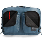 Black Topo Designs Apex Convertible Briefcase with handle and shoulder strap, showcasing its versatile design and sturdy construction.
