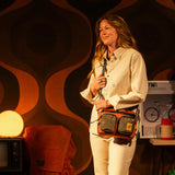 Topo Designs Block Bag crossbody bag with adjustable strap and front pocket, shown in durable fabric with logo patch.