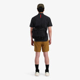 Black Topo Designs Mountain Cross Bag, unisex crossbody bag with adjustable strap and multiple compartments, back view.