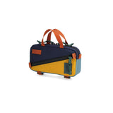 Navy and mustard Topo Designs Mini Quick Pack crossbody bag with adjustable strap and compact storage.