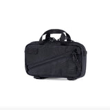 Topo Designs Mini Quick Pack crossbody bag with adjustable strap and compact design, shown in a natural outdoor setting.