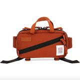 Topo Designs Mini Quick Pack crossbody bag in durable fabric, showing compact design with adjustable strap and top zipper closure.