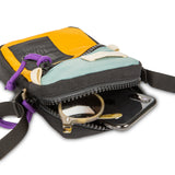 Close-up of Topo Designs Mini Shoulder Bag showcasing its compact design and durable crossbody strap.