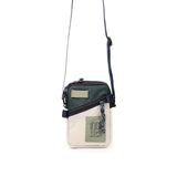 Topo Designs mini shoulder crossbody bag with adjustable strap and compact design, shown in a natural outdoor setting