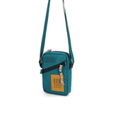 Topo Designs mini shoulder bag, crossbody style, with adjustable strap and durable fabric, shown in a close-up view.