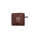 Topo Designs packable tote bag shown open with handles extended and compact design in durable fabric.