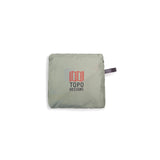 Topo Designs packable tote bag folded with straps visible, lightweight and durable travel accessory in a neutral color.