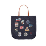 Topo Designs packable tote bag in durable fabric, showing its compact folded form and sturdy handles for versatile use.