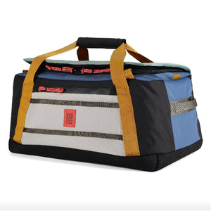 Topo Designs Mountain Duffel 40L in black fabric with sturdy handles and zipper closure, designed for durable travel and outdoor use.