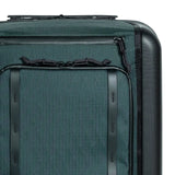 Large Topo Designs Global Pro Travel Roller Bag with multiple compartments and sturdy wheels, ready for travel.