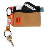 Set of Topo Designs accessory bags in khaki and forest colors with travel accessories for packing organization.