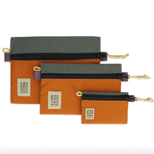 Topo Designs accessory bag bundle with multiple packing organizers in micro, small, and medium sizes, shown in a compact arrangement.