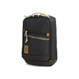 Black Topo Designs mountain sling bag with adjustable strap and compact design for outdoor adventures.