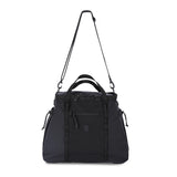 Topo Designs mountain gear tote bag in black, featuring sturdy handles and spacious interior for outdoor adventures and daily use.