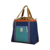 Topo Designs Mountain Utility Tote bag with durable fabric, large main compartment, and adjustable shoulder strap on a plain background.