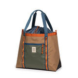Topo Designs Mountain Utility Tote bag in durable fabric with adjustable straps and multiple compartments for versatile carrying.