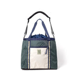 Topo Designs Mountain Utility Tote showing durable canvas material with leather handle accents and spacious interior for versatile use.