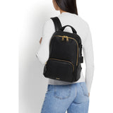Tumi Voyageur Hannah leather backpack showing sleek design, adjustable straps, and front pocket detail.
