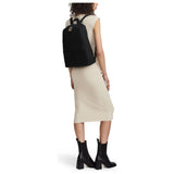 Black Tumi Voyageur Just in Case backpack with gold accents, featuring multiple compartments and a sleek, compact design.