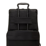 Black Tumi Voyageur Benin laptop carrier with gold accents, showing a sleek design with padded compartments for electronics.