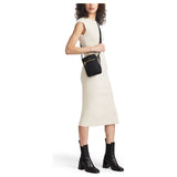 Black Tumi Voyageur Persia Crossbody bag with gold accents, featuring sleek design and adjustable strap for everyday use.