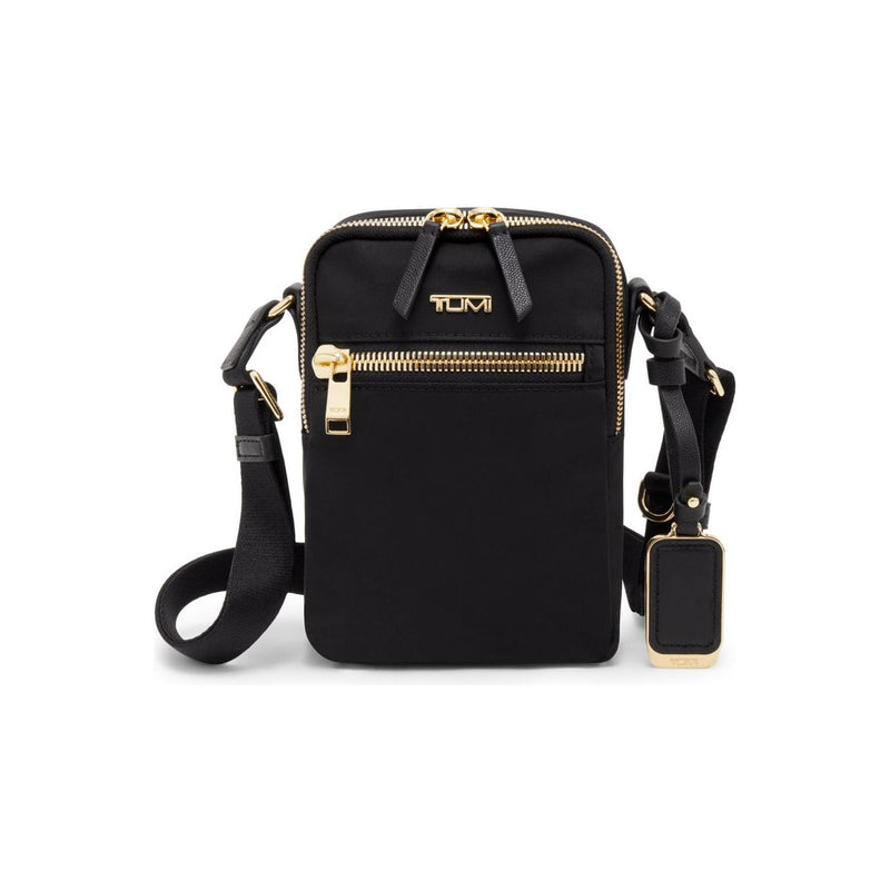 Black Tumi Voyageur Persia Crossbody bag with gold accents, featuring adjustable strap and sleek design for everyday use.