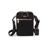 Black Tumi Voyageur Persia Crossbody bag with gold accents, featuring adjustable strap and sleek design for everyday use.