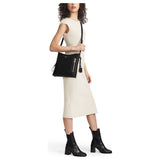 Tumi Voyageur Tyler Crossbody bag in black with adjustable strap and multiple compartments for travel and everyday use.