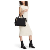 Tumi Voyageur Valetta medium tote bag in black fabric with leather handles and silver hardware, front zip pocket, and spacious interior