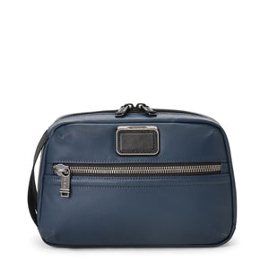 Black Tumi Alpha Bravo Response travel kit with multiple compartments and zipper closures for organizing travel essentials.
