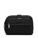 Black Tumi Alpha Bravo Response travel kit with multiple compartments and zippers for organized toiletry storage.