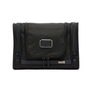 Black Tumi Alpha hanging travel kit with multiple compartments and a zipper closure, designed for organized travel storage.