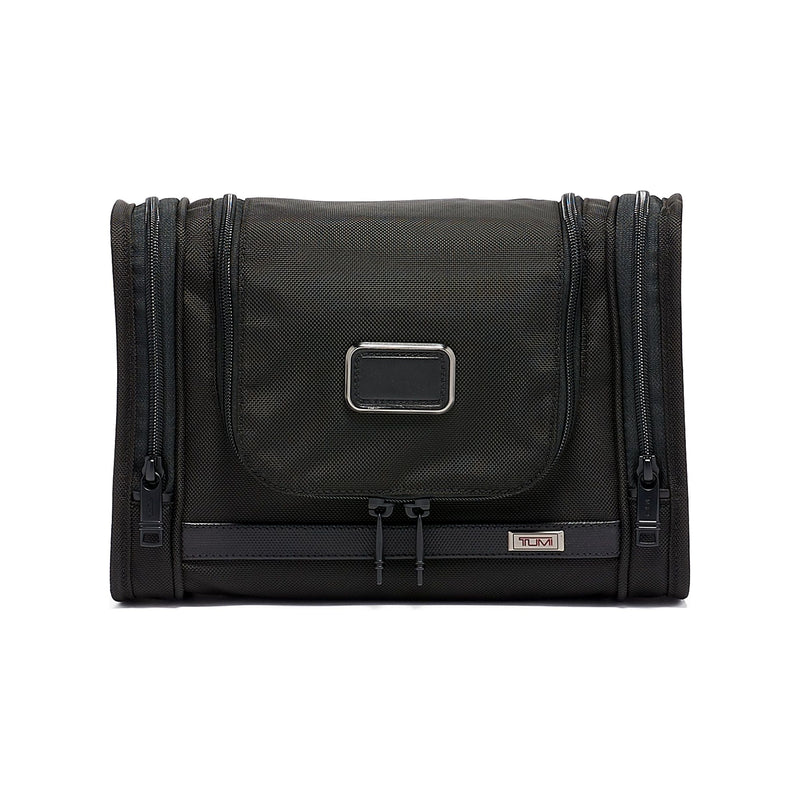 Black Tumi Alpha hanging travel kit with multiple compartments and a zipper closure, designed for organized travel storage.