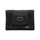 Black Tumi Alpha hanging travel kit with multiple compartments and a zipper closure, designed for organized travel storage.