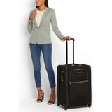 Black Tumi Alpha Short Trip expandable 4-wheeled packing case with black hardware, designed for travel and easy mobility.