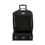 Black Tumi Voyageur Leger compact carry-on luggage with gold accents, lightweight design, and durable wheels.