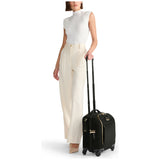 Black Tumi Voyageur Leger compact carry-on luggage with gold accents, lightweight design, and durable hard-shell exterior.