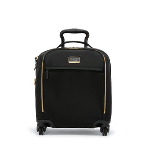 Black Tumi Voyageur lightweight compact carry-on luggage with gold accents, featuring smooth wheels and a sturdy handle.