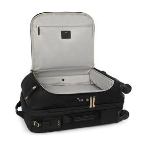 Black Tumi Voyageur Leger International Exp. Carry-On luggage with gold accents, lightweight design, and durable wheels.