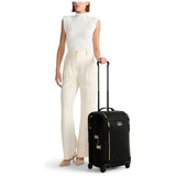 Black Tumi Voyageur Leger international carry-on luggage with gold accents, lightweight design, and durable wheels.