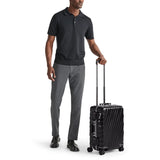 Black Tumi 19 Degree Frame international 4-wheeled carry-on luggage with textured surface and sturdy handle.