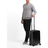Tumi 19 Degree navy polycarbonate international carry-on luggage with four spinner wheels and TSA lock.