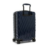 Navy Tumi 19 Degree polycarbonate international carry-on luggage with four wheels and telescoping handle for easy travel mobility.