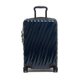 Navy Tumi 19 Degree polycarbonate carry-on luggage with four wheels and telescopic handle for international travel.
