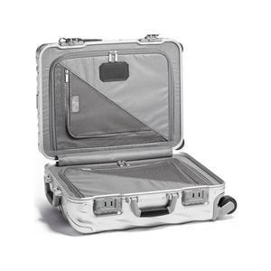 Silver Tumi 19 Degree aluminum carry-on luggage with hard shell and four wheels for easy international travel.