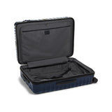 Navy Tumi 19 Degree polycarbonate checked luggage with extended handle and four spinner wheels for easy travel.