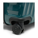 Navy Tumi 19 Degree polycarbonate checked luggage with extended handle and four spinner wheels for easy travel.